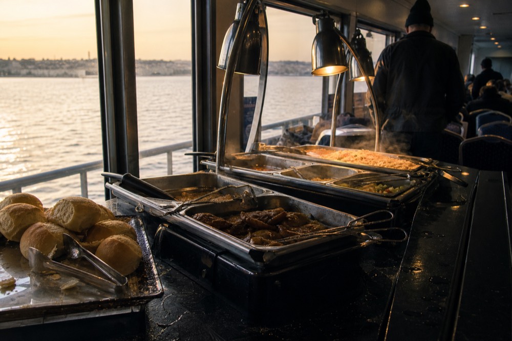 A buffet dinner station on a multi-deck cruise vessel on Boston Harbor