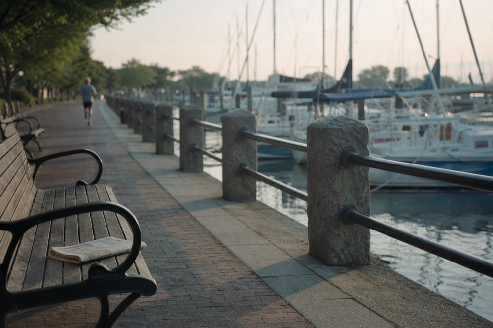 Boston Harborwalk path along the waterfront with boats moored nearby