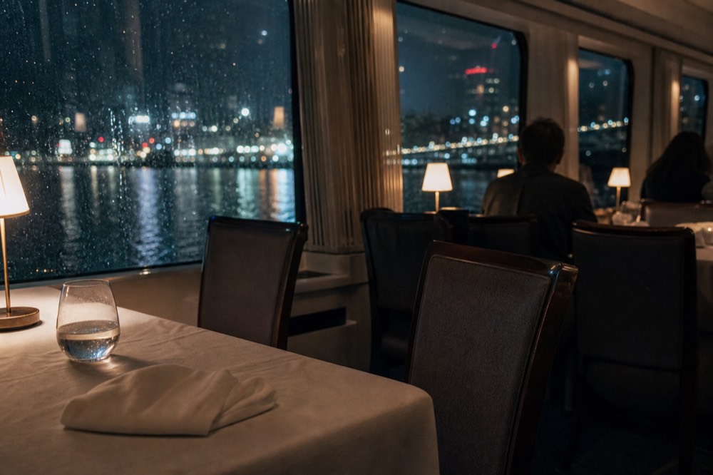 Odyssey dinner cruise interior with white tablecloths and harbor view