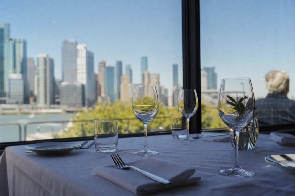 Boston Harbor dinner cruise table setting with skyline