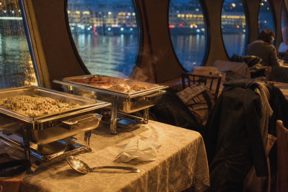 Casual dinner outfits at a buffet table on a cruise ship interior