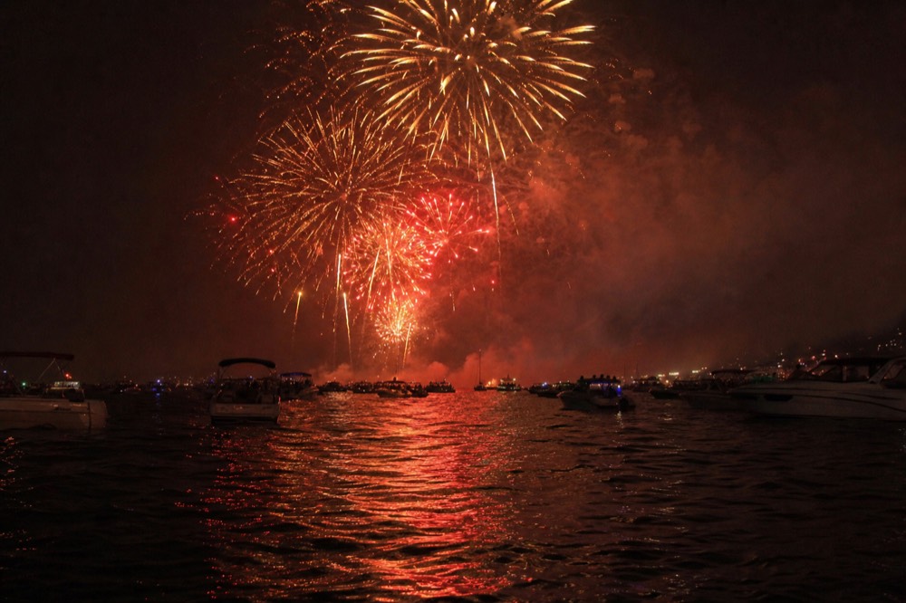 Fireworks bursting over Boston Harbor as seen from the water