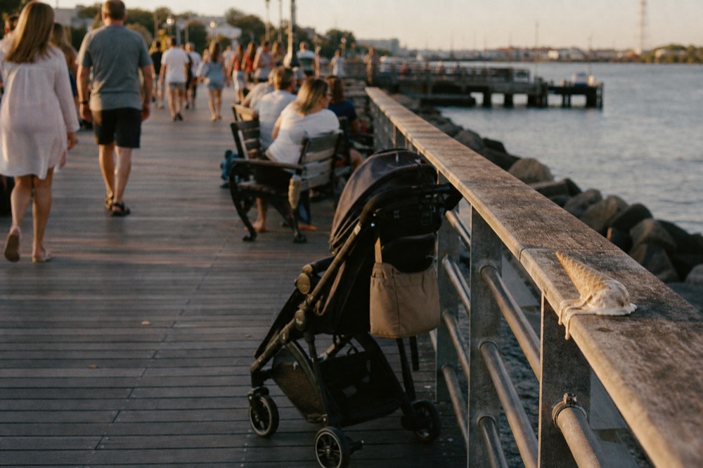 Busy Boston waterfront promenade on a summer evening