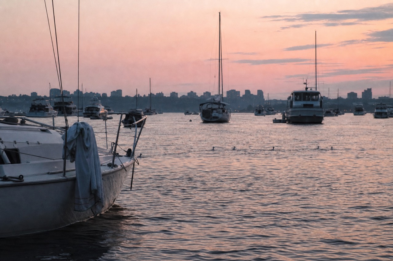 Boston Harbor at dusk with boats on the water