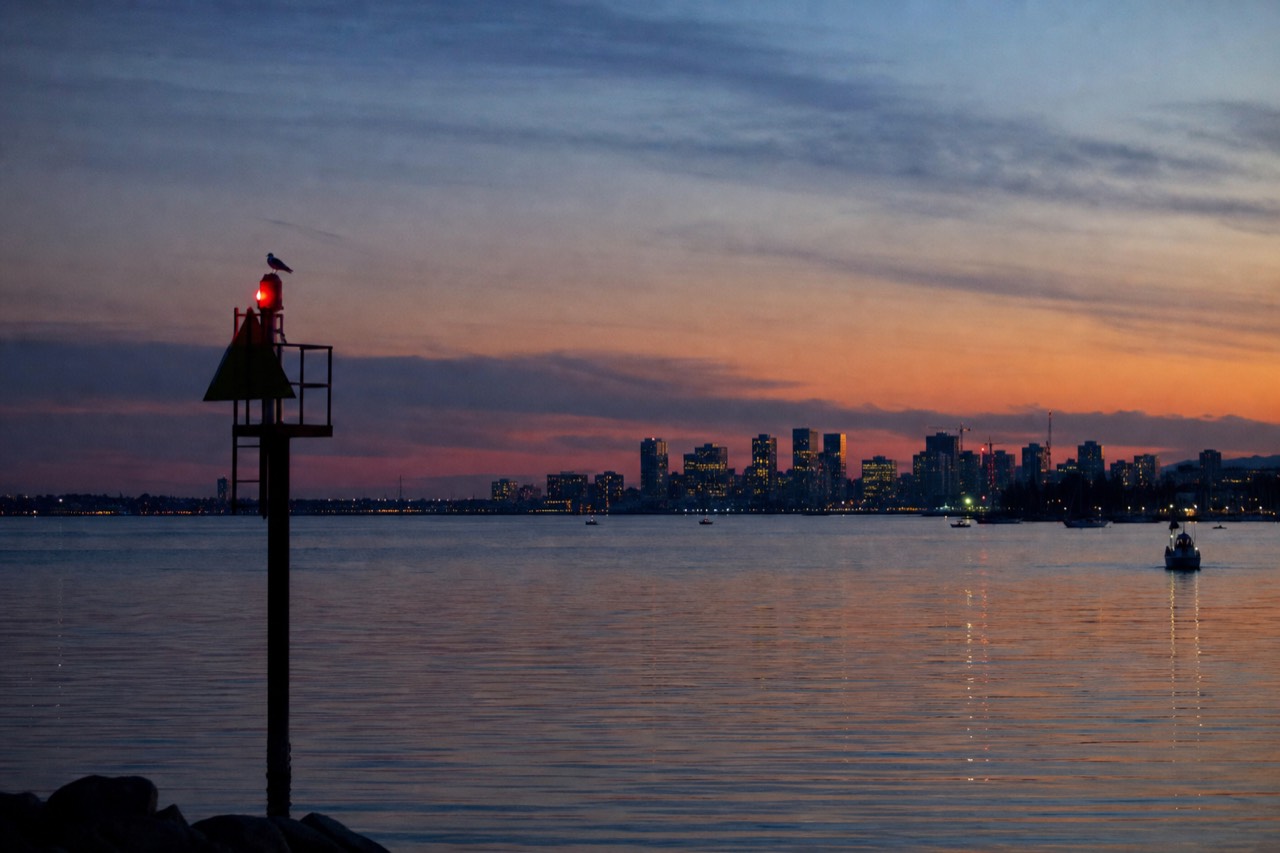 Boston Harbor at dusk with city skyline and calm water