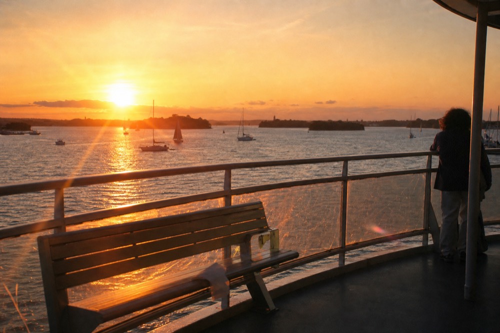 Boston Harbor at sunset from a cruise deck