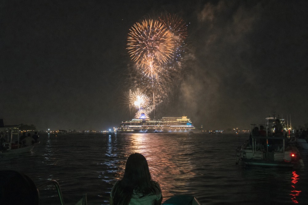 Fireworks display over Boston Harbor with a cruise ship in view