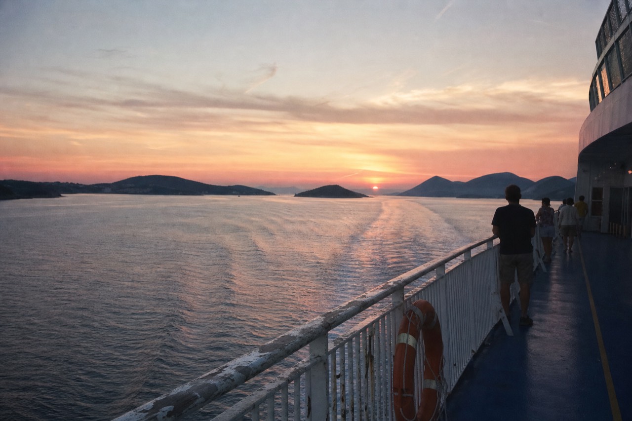 Sunset over Boston Harbor seen from a cruise ship deck