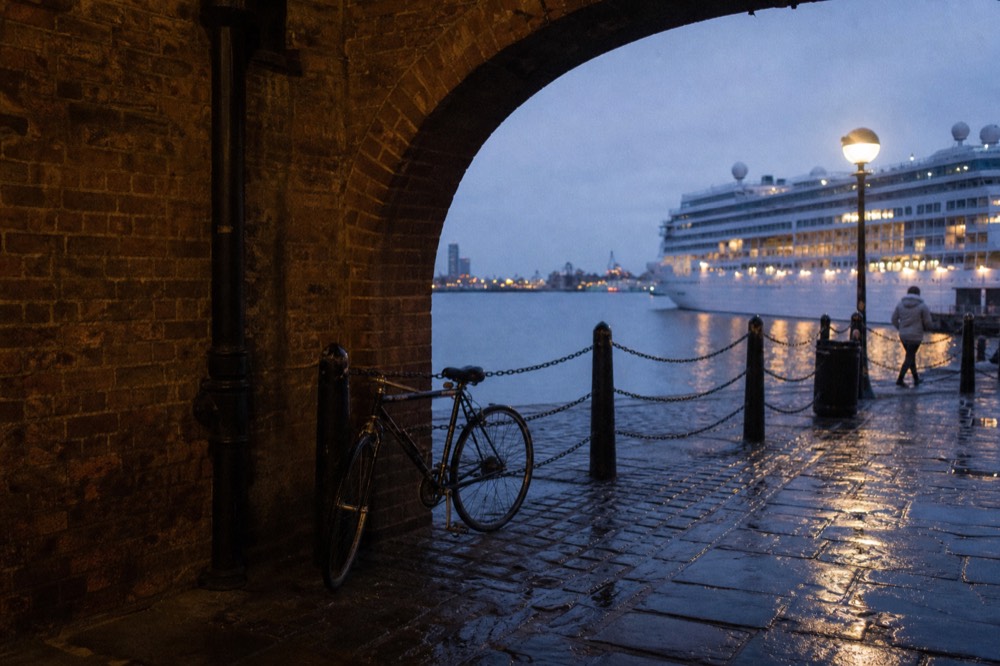 The Rowes Wharf arch on the Boston waterfront with a cruise vessel moored behind it