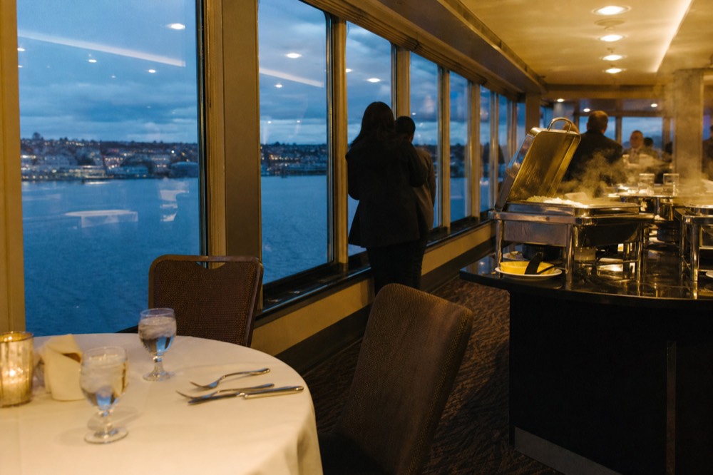 Buffet dinner stations set along a climate-controlled cruise dining deck